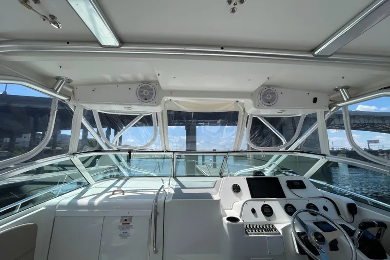Slide: The Image of 2002 Wellcraft 290 Coastal boat interior with steering wheel and seating area. - 12