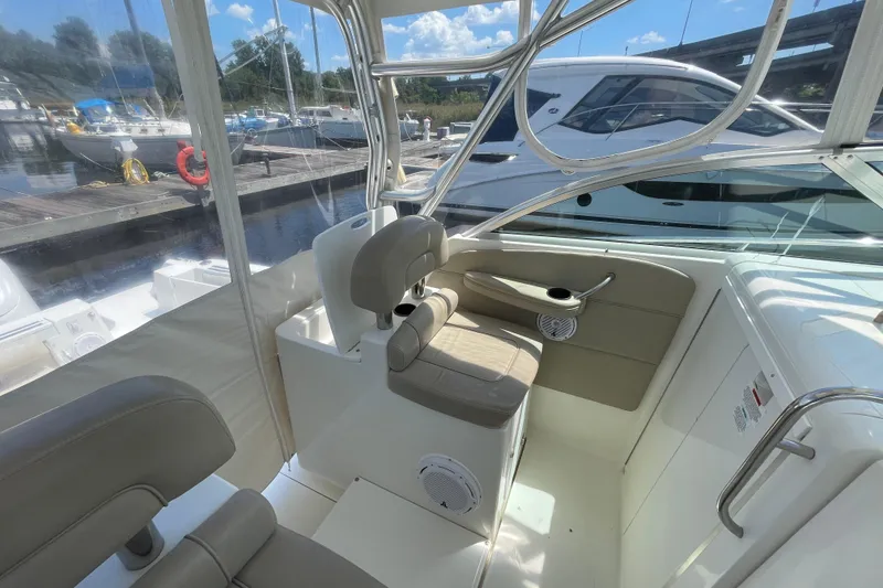 Slide: The Image of 2002 Wellcraft 290 Coastal boat interior with helm, steering wheel, and navigation equipment. - 14