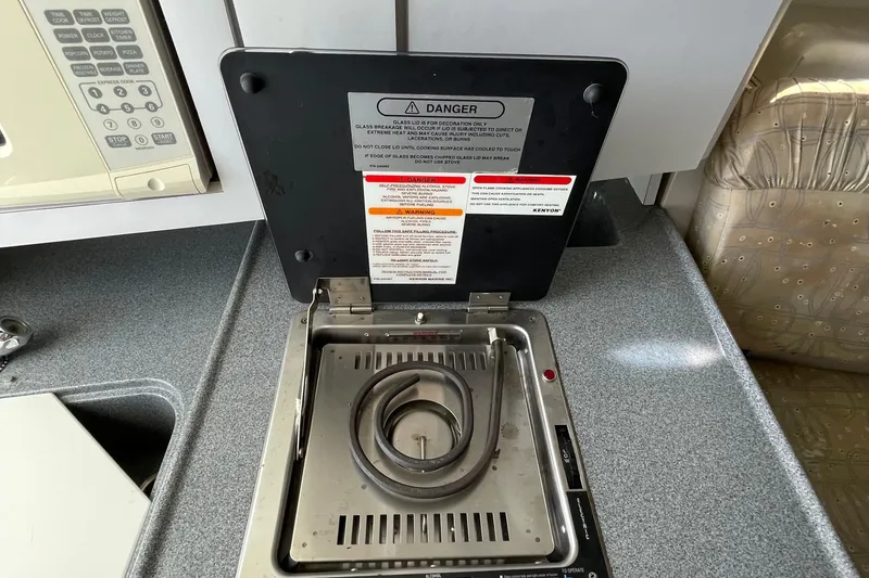 Slide: The Image of 2002 Wellcraft 290 Coastal boat interior with sink and seating, docked at marina. - 18