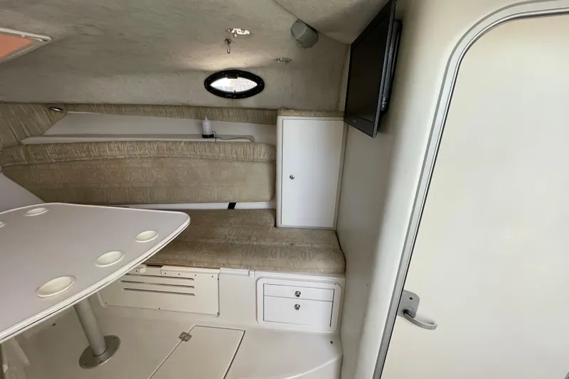 Slide: The Image of Interior cabin of 2002 Wellcraft 290 Coastal boat with patterned carpet and seating area. - 21