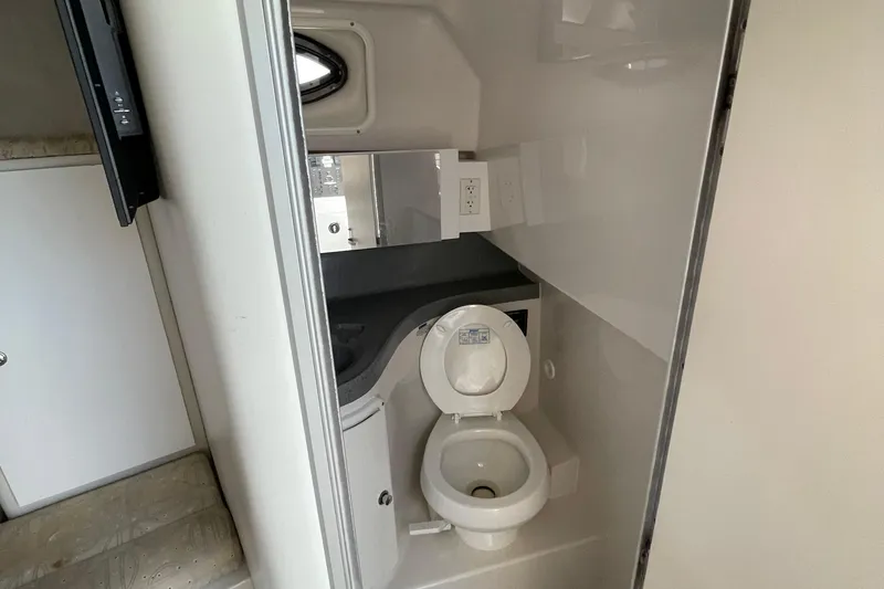 Slide: The Image of Electric stove in 2002 Wellcraft 290 Coastal boat kitchen, featuring safety instructions. - 24