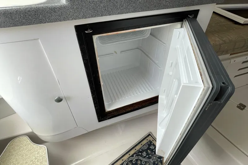 Slide: The Image of Open mini fridge inside 2002 Wellcraft 290 Coastal boat cabin. - 26