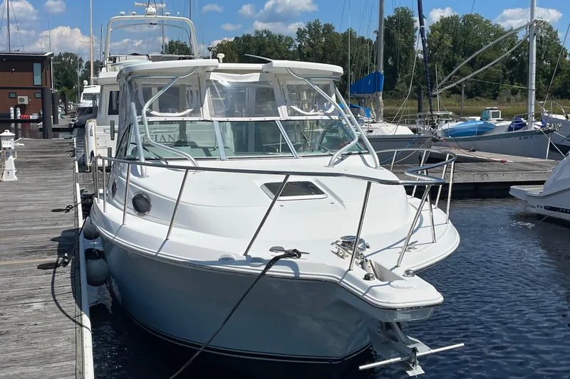 Slide: The Image of 2002 Wellcraft 290 Coastal boat docked at marina, surrounded by other vessels. - 6