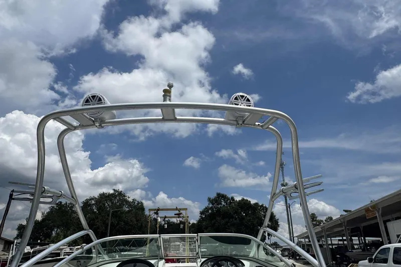 Slide: The Image of 2011 Sea Ray 205 Sport boat with wakeboard tower under a blue sky. - 3
