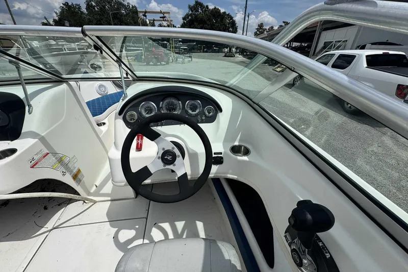 Slide: The Image of 2011 Sea Ray 205 Sport boat dashboard with steering wheel and control panel. - 5