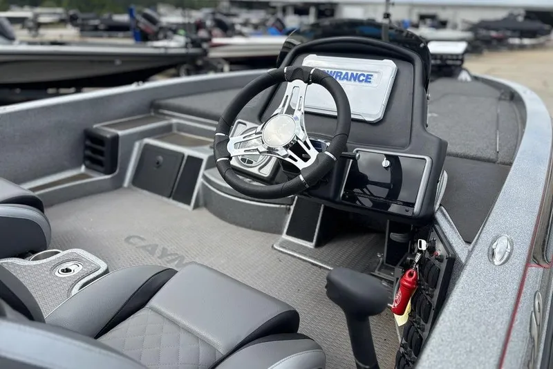 Slide: The Image of 2023 Caymas CX 19 boat interior with steering wheel and seating, showcasing modern design. - 10