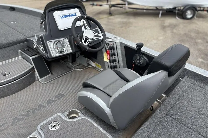 Slide: The Image of 2023 Caymas CX 19 boat cockpit with steering wheel and seat, featuring Lowrance electronics. - 12