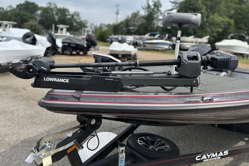Slide: The Image of 2023 Caymas CX 19 boat with Lowrance Ghost trolling motor, parked outdoors. - 15