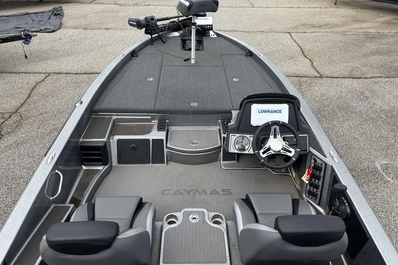 Slide: The Image of 2023 Caymas CX 19 boat interior with steering wheel and Lowrance electronics. - 16