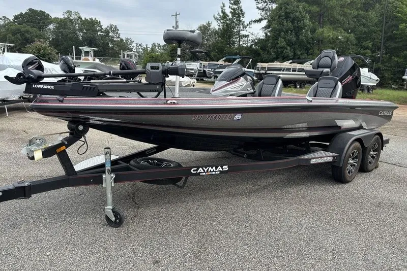 Slide: The Image of 2023 Caymas CX 19 boat on trailer, featuring Lowrance equipment, parked outdoors. - 3