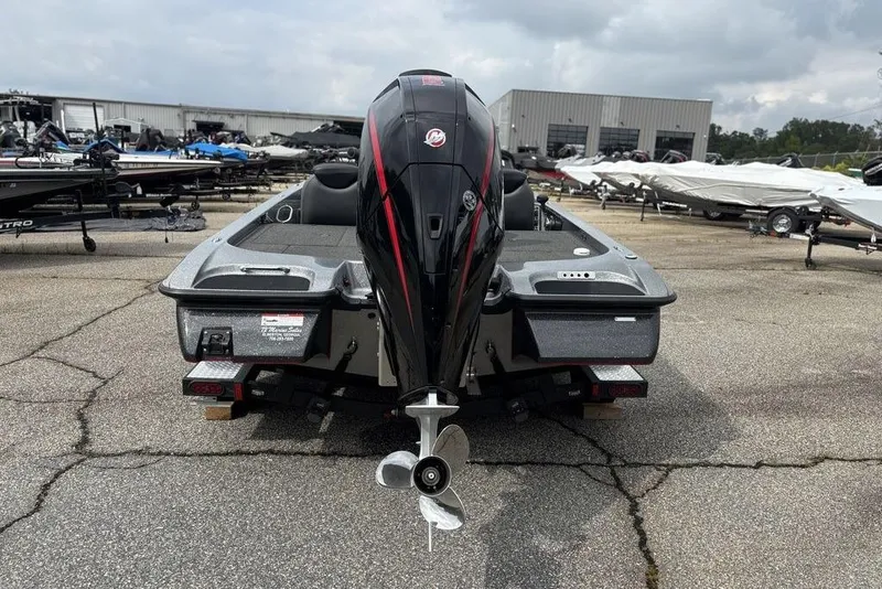 Slide: The Image of 2023 Caymas CX 19 boat with powerful outboard motor, parked in a marina. - 6