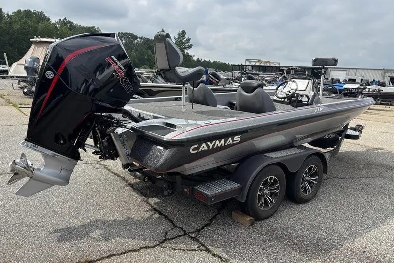 Slide: The Image of 2023 Caymas CX 19 boat with powerful outboard motor, parked on a trailer in a marina. - 9