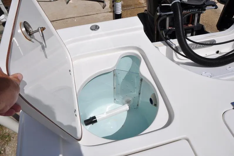 Slide: The Image of 2021 Sea Pro 228 Bay boat livewell with open lid, showcasing interior features. - 10