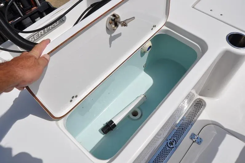 Slide: The Image of 2021 Sea Pro 228 Bay boat livewell with open lid and plumbing details. - 11
