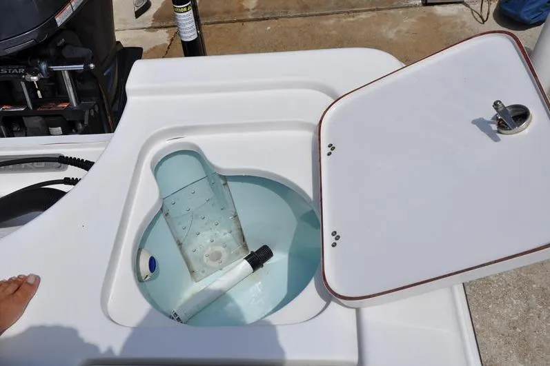 Slide: The Image of Livewell on a 2021 Sea Pro 228 Bay boat with open lid and water inside. - 12