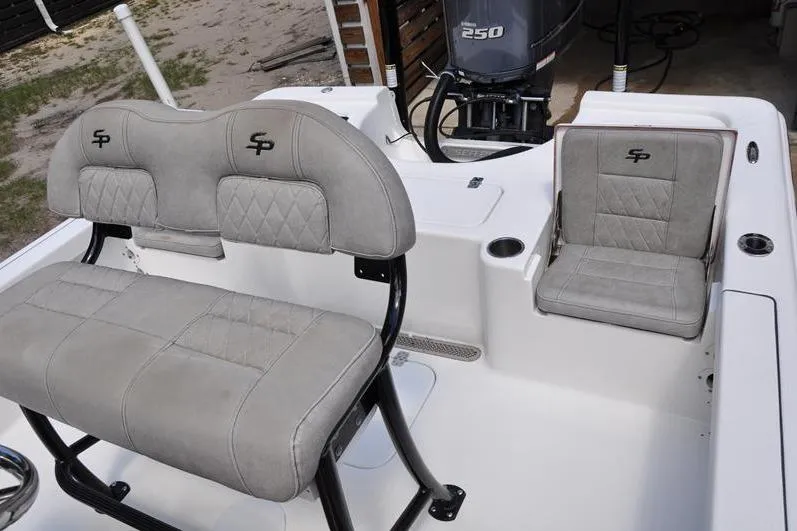 Slide: The Image of 2021 Sea Pro 228 Bay boat interior with cushioned seating and 250 horsepower engine. - 14