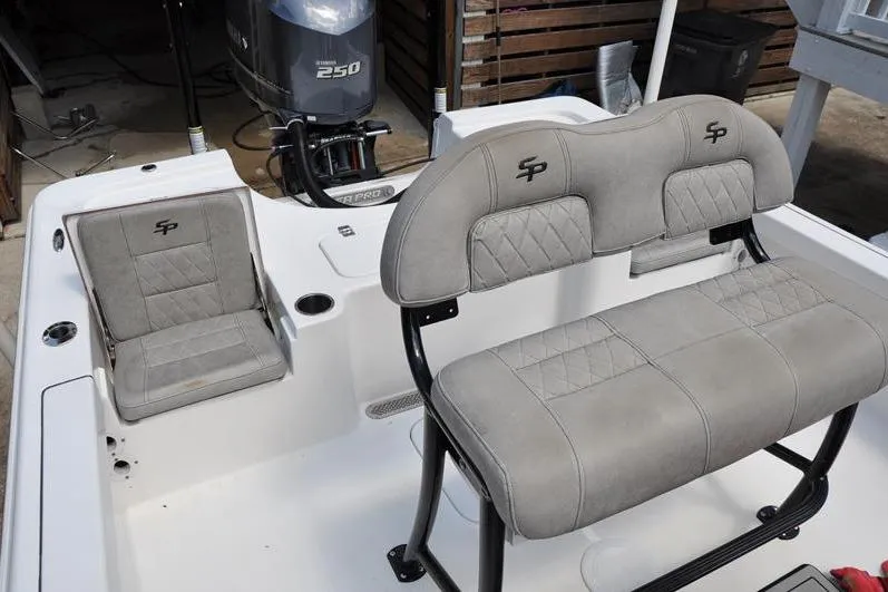 Slide: The Image of 2021 Sea Pro 228 Bay boat interior with cushioned seating and Yamaha 250 engine. - 15
