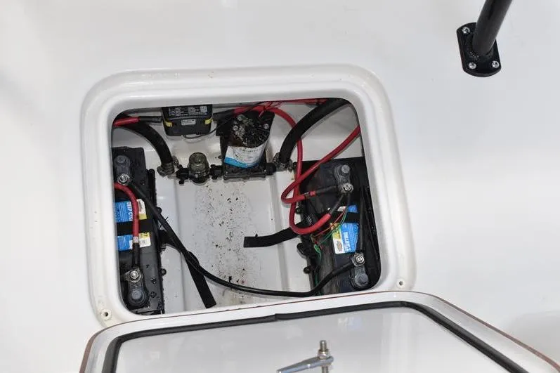 Slide: The Image of 2021 Sea Pro 228 Bay boat battery compartment with wiring and components. - 16