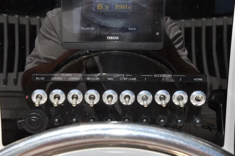 Slide: The Image of Control panel of a 2021 Sea Pro 228 Bay boat with Yamaha display and switches. - 19