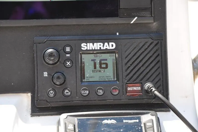 Slide: The Image of Simrad marine radio displaying channel 16 distress signal on a 2021 Sea Pro 228 Bay boat. - 21