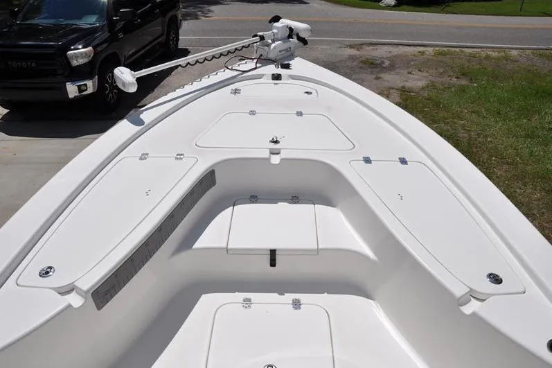 Slide: The Image of 2021 Sea Pro 228 Bay boat deck with storage compartments and trolling motor. - 26
