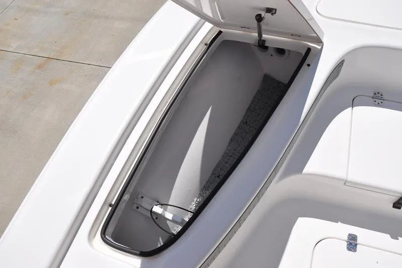 Slide: The Image of 2021 Sea Pro 228 Bay boat storage compartment with open lid, showcasing interior space. - 27