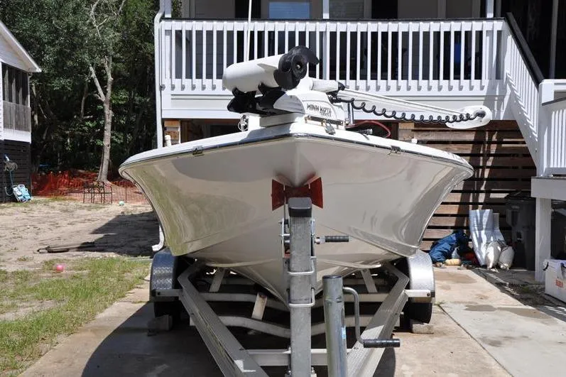 Slide: The Image of 2021 Sea Pro 228 Bay boat on trailer, parked in front of a house. - 3