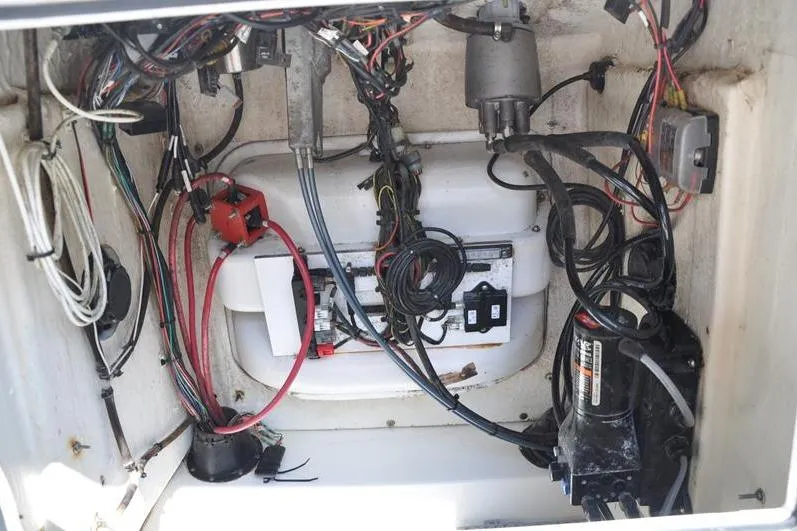Slide: The Image of 2021 Sea Pro 228 Bay boat wiring and electrical components inside compartment. - 32
