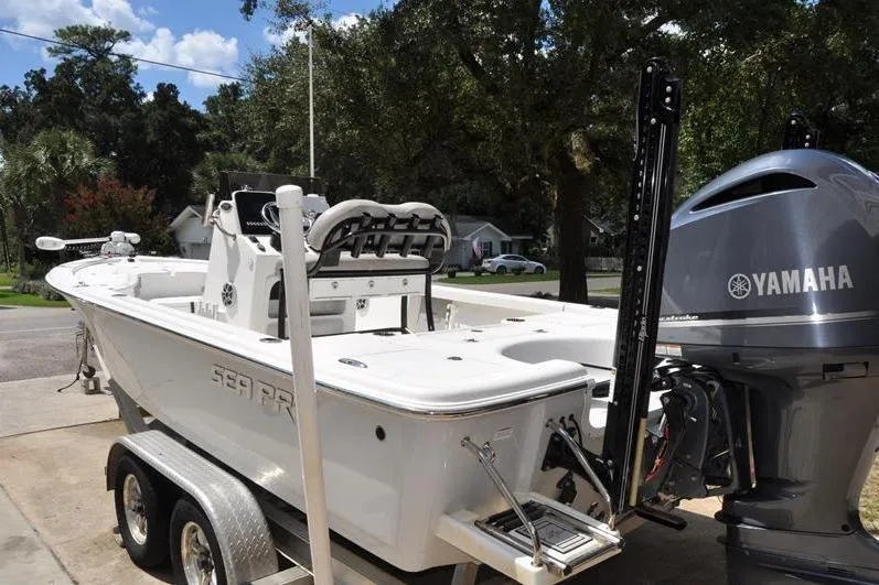 Slide: The Image of 2021 Sea Pro 228 Bay boat with Yamaha engine on trailer, parked outdoors. - 5