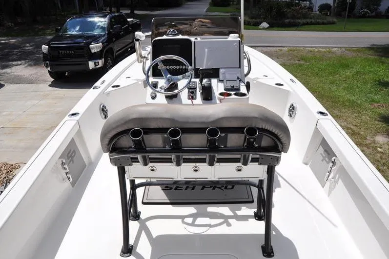 Slide: The Image of 2021 Sea Pro 228 Bay boat interior with steering console and rod holders. - 8