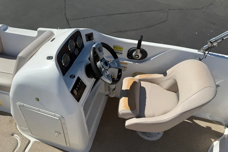 Slide: The Image of Interior of a 2013 Hurricane 188 boat showing steering console and captain's chair. - 15