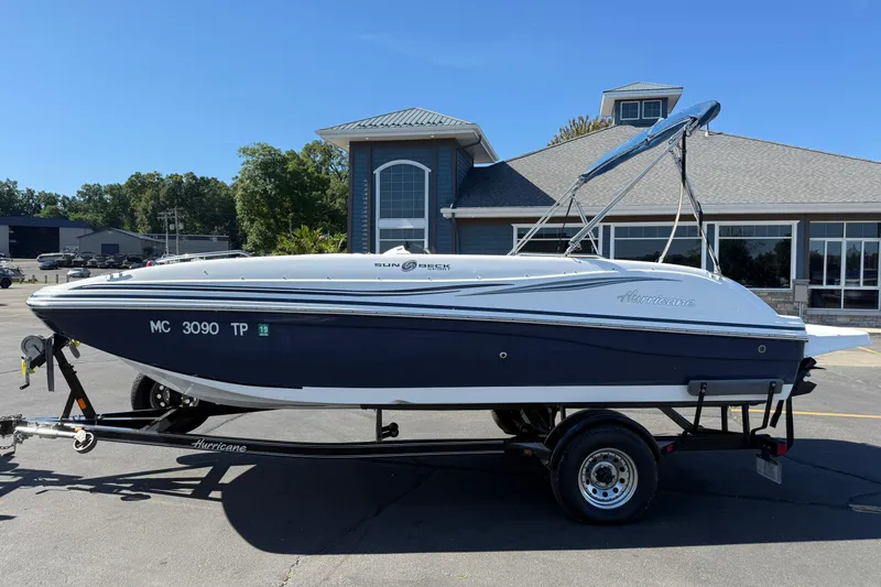 Slide: The Image of 2013 Hurricane 188 boat on trailer, parked outside a building. - 16