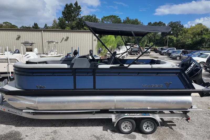 The Image of 2026 Viaggio Lago V 20 C pontoon boat on trailer, featuring Suzuki outboard motor. - 0
