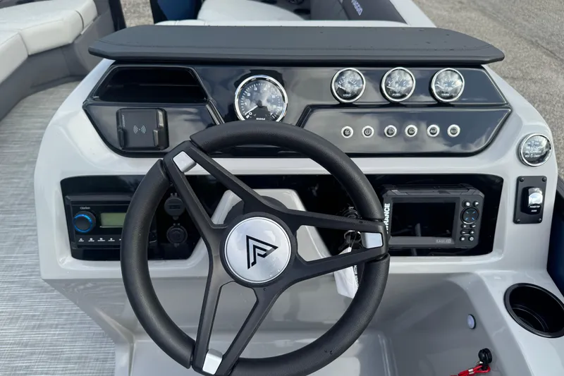 Slide: The Image of 2026 Viaggio Lago V 20 C boat dashboard with steering wheel and control panel. - 18