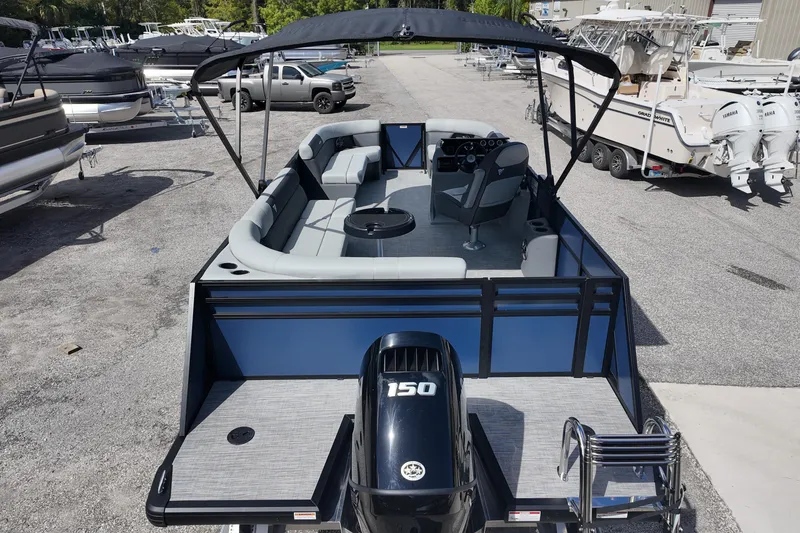 Slide: The Image of 2026 Viaggio Lago V 20 C pontoon boat with 150 HP engine, docked in a marina. - 21