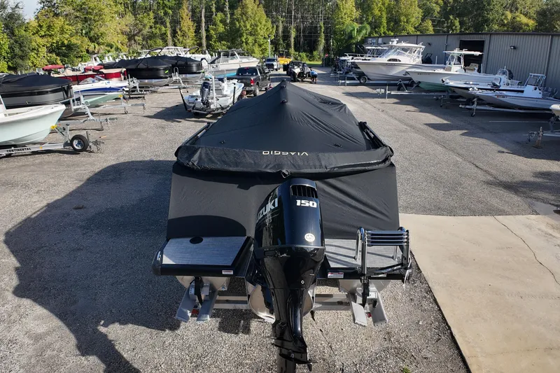 Slide: The Image of Covered Viaggio Lago V 20 C boat with Suzuki 150 engine in a boatyard, 2026 model. - 6