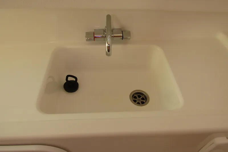 Slide: The Image of Modern sink with chrome faucet in 2025 Nimbus Tender 9 boat interior. - 25