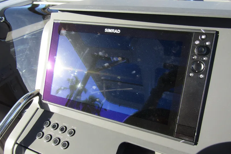 Slide: The Image of Simrad display on 2025 Nimbus Tender 9 boat dashboard, reflecting sunlight. - 15