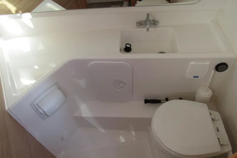 Slide: The Image of Compact bathroom in 2025 Nimbus Tender 9 boat, featuring sink and toilet. - 23