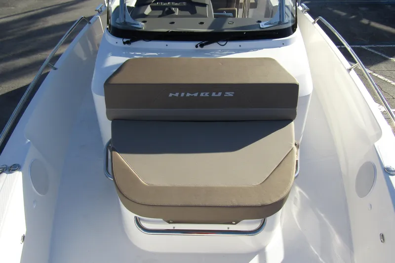Slide: The Image of 2025 Nimbus Tender 9 boat with cushioned seating and sleek design. - 11