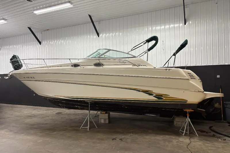 The Image of 1999 Sea Ray 270 Sundancer boat in indoor storage on stands. - 1