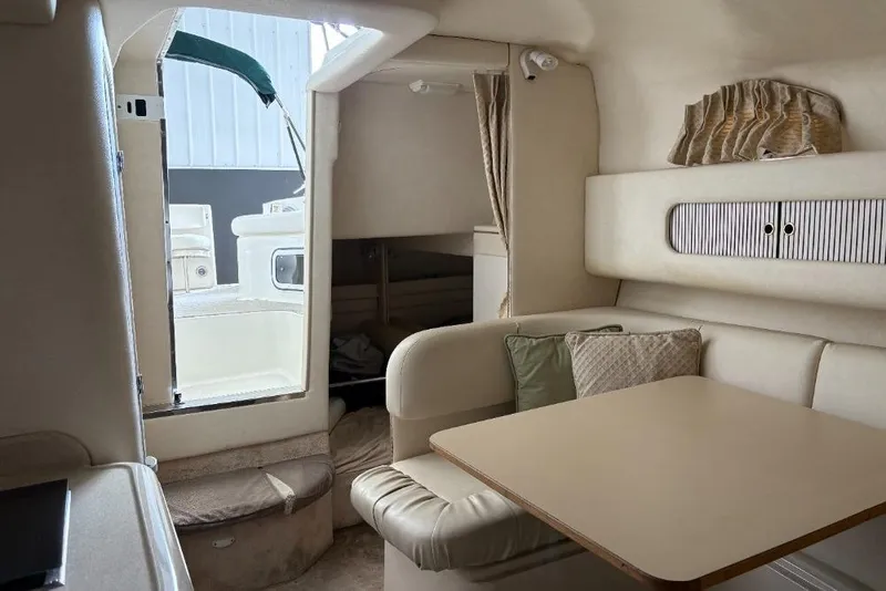 Slide: The Image of Interior of 1999 Sea Ray 270 Sundancer boat with seating and table. - 6
