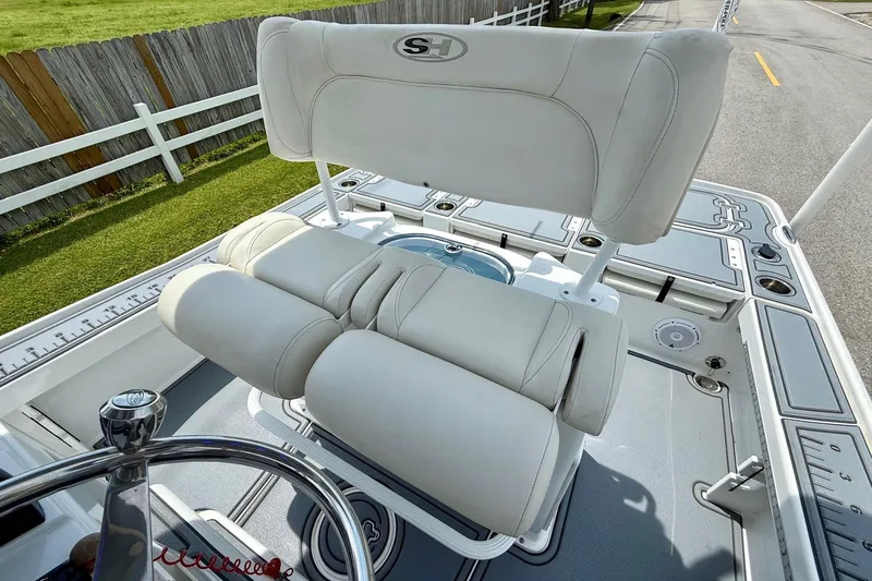 Slide: The Image of 2021 Sea Hunt BX 22 BR boat with white cushioned seating and steering wheel. - 10
