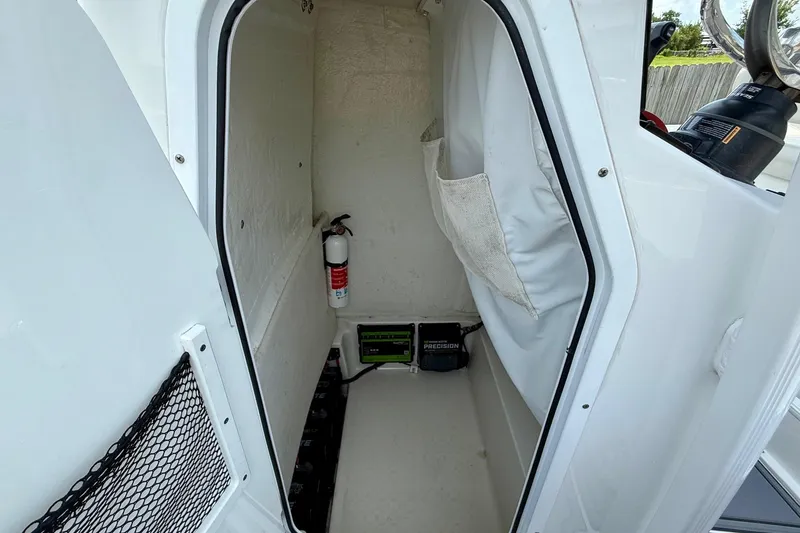 Slide: The Image of Interior of 2021 Sea Hunt BX 22 BR boat with storage and fire extinguisher. - 14