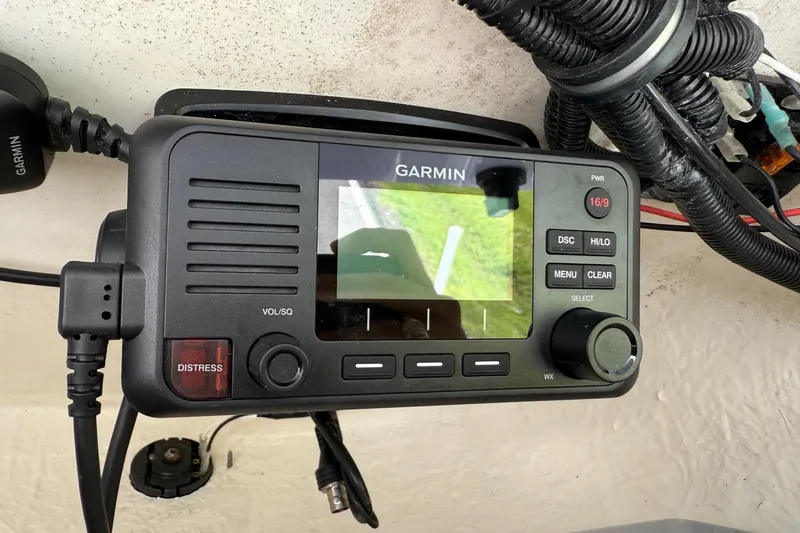 Slide: The Image of Garmin marine radio on 2021 Sea Hunt BX 22 BR boat dashboard, featuring distress button. - 23