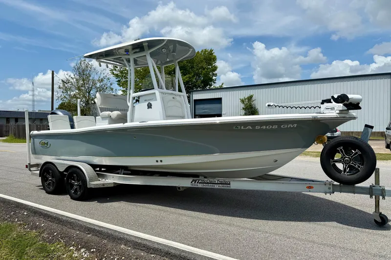 Slide: The Image of 2021 Sea Hunt BX 22 BR boat on trailer, parked outdoors under a cloudy sky. - 5
