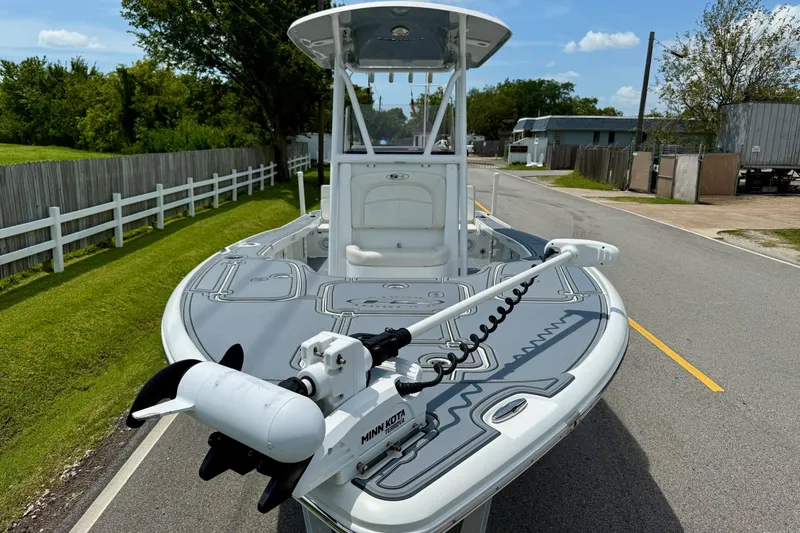 Slide: The Image of 2021 Sea Hunt BX 22 BR boat with trolling motor on a sunny street. - 6
