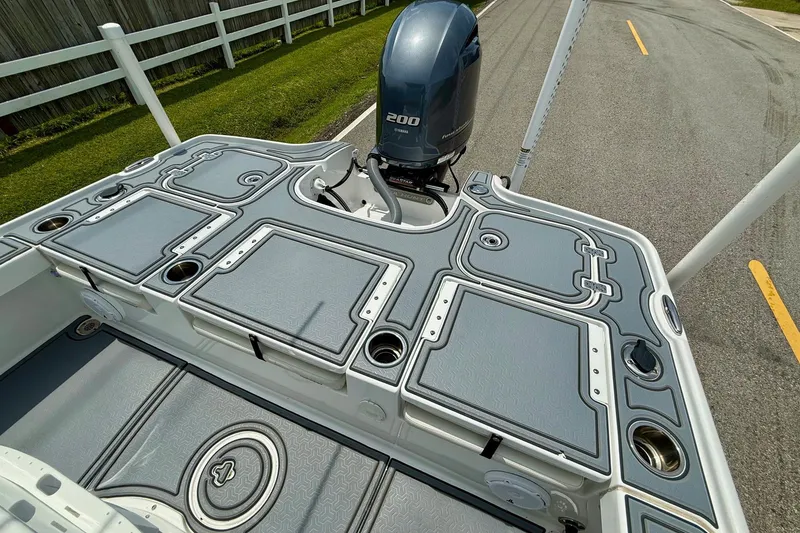Slide: The Image of 2021 Sea Hunt BX 22 BR boat deck with Yamaha 200 engine, featuring storage compartments. - 8
