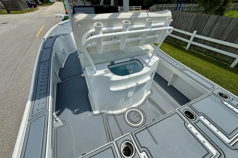 Slide: The Image of 2021 Sea Hunt BX 22 BR boat interior with rod holders and storage compartments. - 9