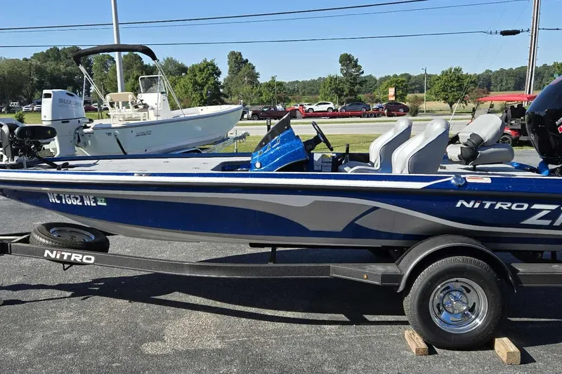 Slide: The Image of 2024 Nitro Z18 boat on trailer, blue and gray design, parked outdoors. - 1